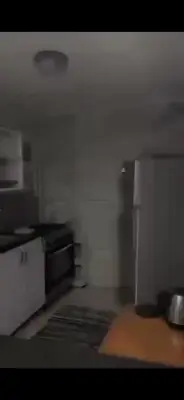 a small kitchen with a stove and a refrigerator at مخيم الخال in Yarqā