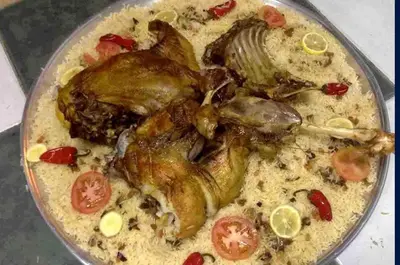 a plate of food with fish and tomatoes at مخيم الخال in Yarqā