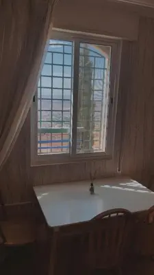 a window with a vase on a table in a room at شقق ڤيڤا - viva Apartments in Amman