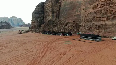 a group of buildings in the desert near a mountain at Rum bubble camp in Wadi Rum
