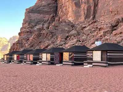 a row of buildings in front of a mountain at Rum bubble camp in Wadi Rum