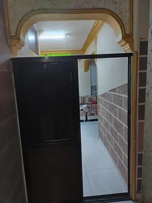 a door in a room with a brick wall at شقة الياسمين عمّان الأرضيّة للعائلات in Amman