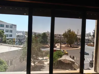 a view of a city from a window at Stay with Saja Homey Room Heart of Weibdeh in Jurf ad Darāwīsh
