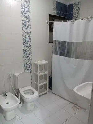 a bathroom with a toilet and a sink and a shower at Stay with Saja Homey Room Heart of Weibdeh in Jurf ad Darāwīsh