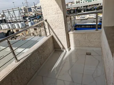 a view of a balcony with stairs and a street at Furnished apartment - Irbid in Irbid