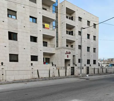 an empty street in front of a building at Furnished apartment - Irbid in Irbid