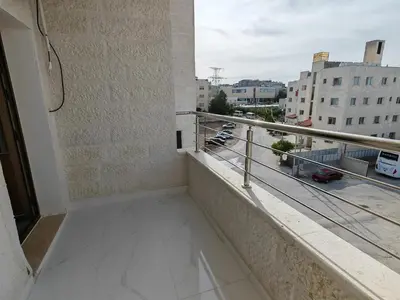 a balcony with a view of a city at Furnished apartment - Irbid in Irbid