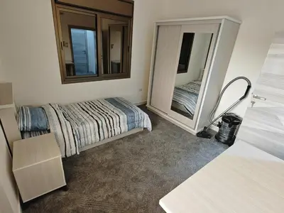 a bedroom with a bed and a mirror at Furnished apartment - Irbid in Irbid