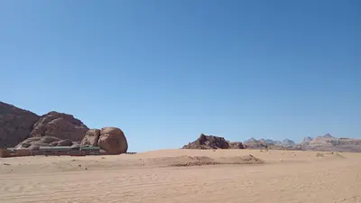 a campsite in the desert near some rocks at Wasan Camp Wadi Rum in Wadi Rum