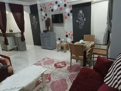 a living room with a couch and a table at ايدون هاوس in Aydūn