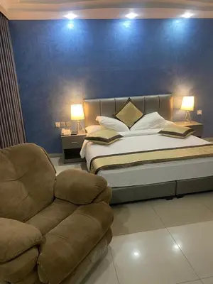 a bedroom with a large bed and a couch at Tetra Tree Hotel 1 in Wadi Musa