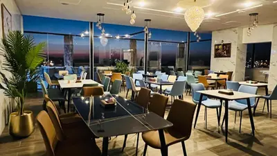 a restaurant with tables and chairs with a view at Tetra Tree Hotel 1 in Wadi Musa