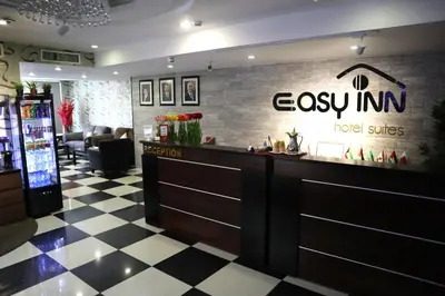 a bar in a restaurant with a checkered floor at Easy Inn Hotel Suites in Amman