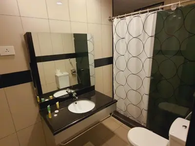 a bathroom with a sink and a mirror at Easy Inn Hotel Suites in Amman