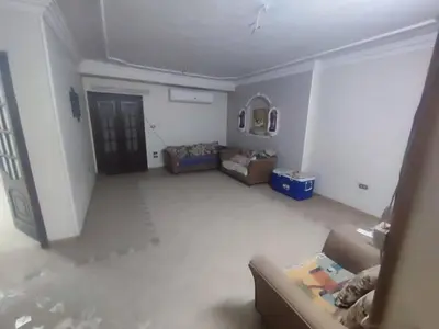 an empty living room with a couch and a table at الاغوار هاوس in Khirbat ash Shaykh Muḩammad