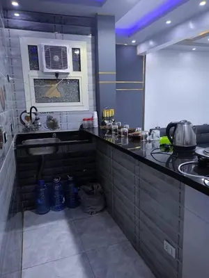 a kitchen with a sink and a microwave at الاغوار هاوس in Khirbat ash Shaykh Muḩammad