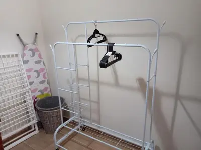 a metal rack with hangers in a room at Stay with Saja Room in Weibdeh in Jurf ad Darāwīsh