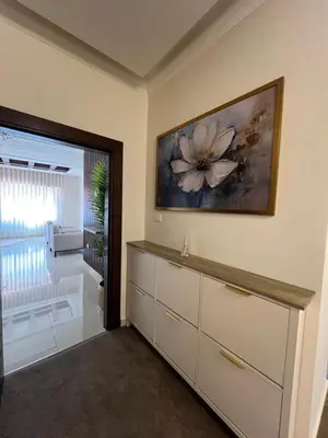 a room with a dresser and a painting on the wall at Modern Luxe Getaway in Amman