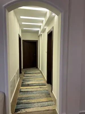 an empty hallway with a rug on the floor at Modern Luxe Getaway in Amman