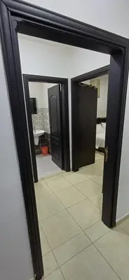 a mirror with a reflection of a bathroom at شقق الجبيهة العائلية in Amman