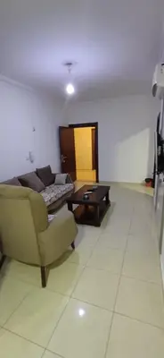 a living room with a couch and a coffee table at شقق الجبيهة العائلية in Amman