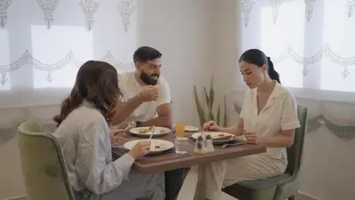 a group of people sitting at a table eating food at فندق الأمراء بلازا in Ma‘ān