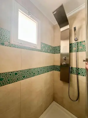 a bathroom with a shower and a window at الصدقه ان in Aş Şadaqah