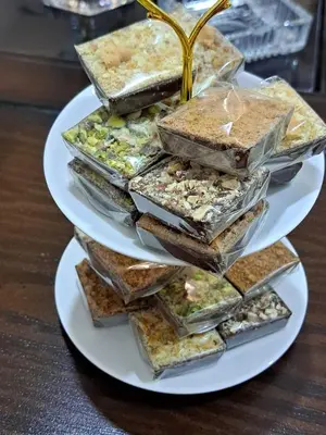 a stack of three plates of food on a table at الصدقه ان in Aş Şadaqah
