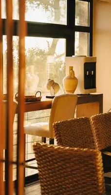 a room with a table with a chair and a window at Al Bader Resort in Jurf ad Darāwīsh