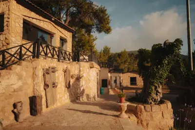 a stone building with a tree in front of it at Al Bader Resort in Jurf ad Darāwīsh