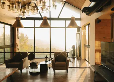 a living room with chairs and a large window at Al Bader Resort in Jurf ad Darāwīsh