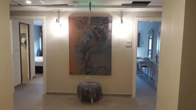 a hallway with a painting on the wall at Layaali Amman Hotel Airport Pickup in Amman