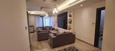 a living room with a couch and a table at فورتاليزا للإسكان in Jurf ad Darāwīsh