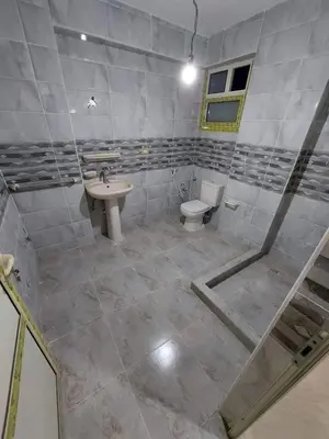 a bathroom with a sink and a toilet at صبحه هاوس in Şabḩā