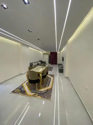 a dining room with a table and chairs on a rug at شلنر موتل in Khirbat ar Ruşayfah