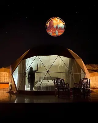 a man standing in a tent in a room at RUM DREAM CITY lUXURY CAMP in Wadi Rum