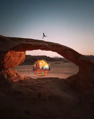 a person jumping over a rock arch in the desert at RUM DREAM CITY lUXURY CAMP in Wadi Rum