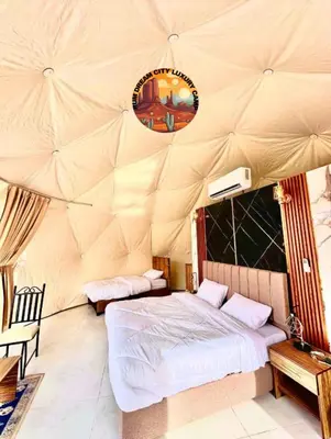 a bedroom with a bed in a tent at RUM DREAM CITY lUXURY CAMP in Wadi Rum