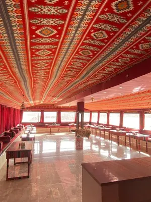 a large room with tables and chairs in a building at Wadi Rum Desert Experience in Wadi Rum