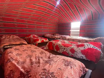a room with a bunch of beds in it at Wadi Rum Desert Experience in Wadi Rum