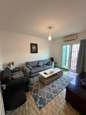 a living room with a couch and a table at MK4 - One Bedroom Apartment in Amman