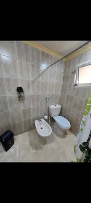 a bathroom with a toilet and a bidet at Central Jabal Alweibdeh in Amman