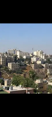 a view of a city with buildings in the background at Central Jabal Alweibdeh in Amman