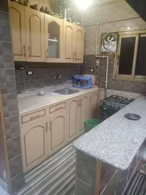 a kitchen with white cabinets and a sink and a stove at المزار لوج in Al Mazār
