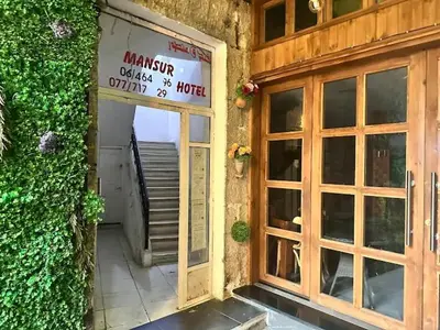 a door to a building with a sign on it at man -soor in Amman