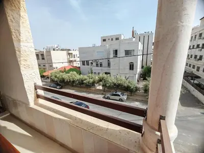 a view of a city street from a building at Khalda One Bedroom Apt in Amman