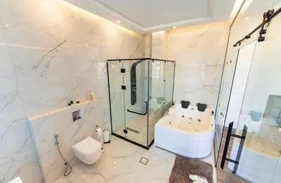 a bathroom with a shower and a toilet and a sink at Bow Villa in Sowayma