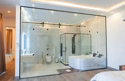 a bathroom with a glass shower with a tub and a sink at Bow Villa in Sowayma