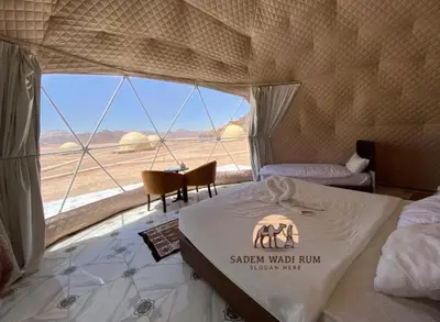 a bedroom with a bed and a view of the desert at SADEM WADl RUM in Wadi Rum