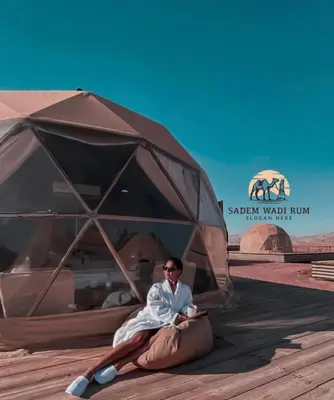 a man laying on the ground under a tent at SADEM WADl RUM in Wadi Rum